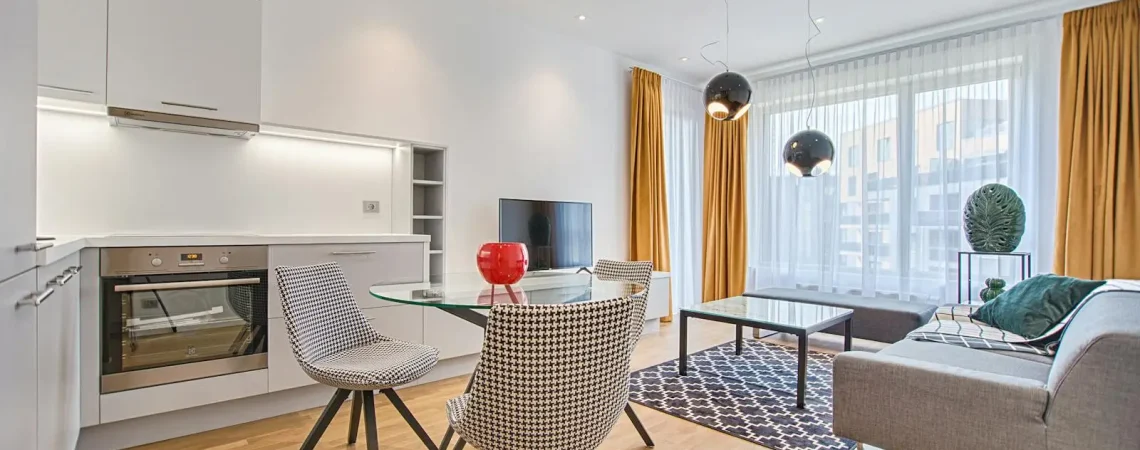 Elegant Scandinavian-style living room and kitchen featuring modern furniture and decor.